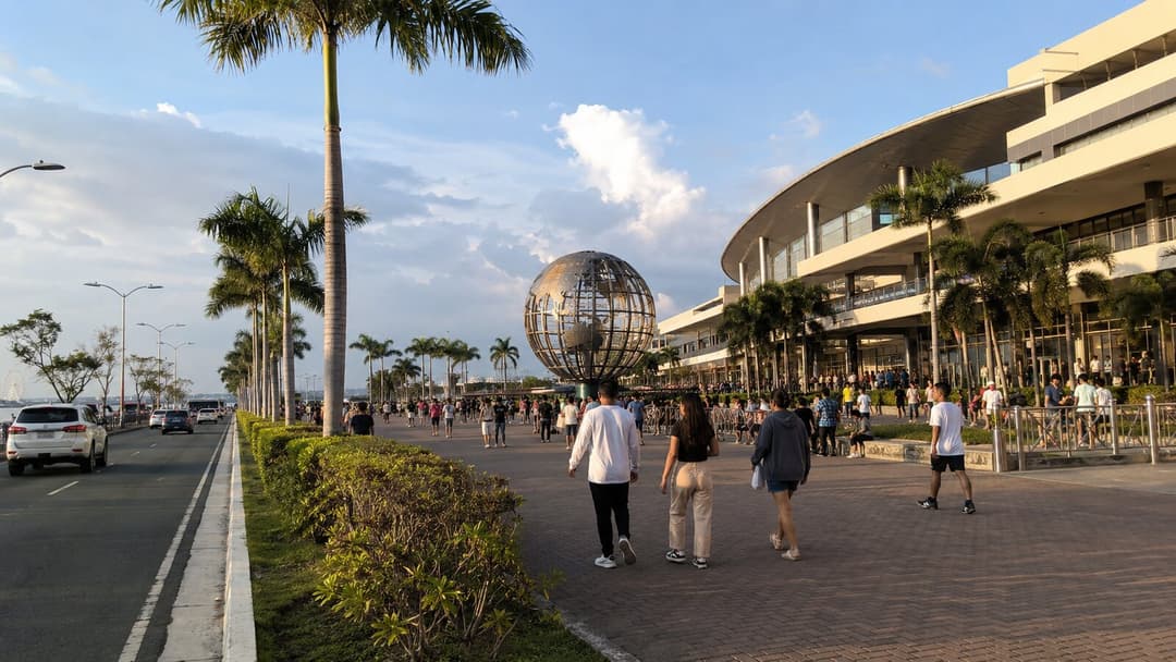 Visitors walking near the SM Mall of Asia waterfront district in Pasay
