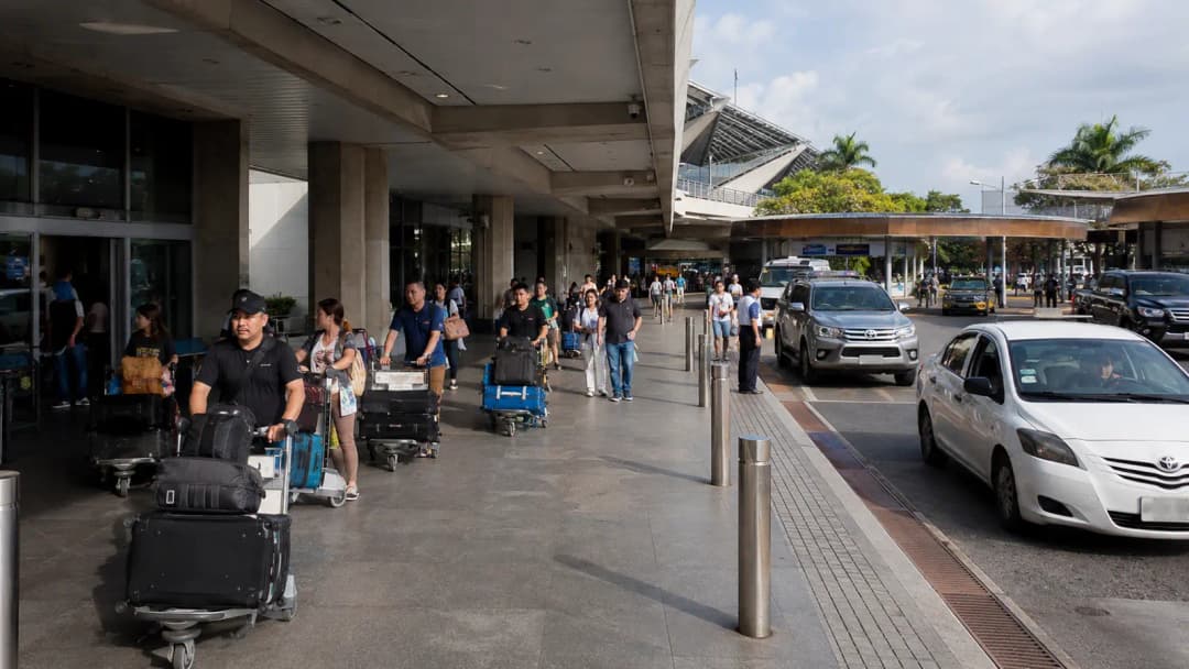 International travelers leaving the covered arrival curb at Manila airport Terminal 1