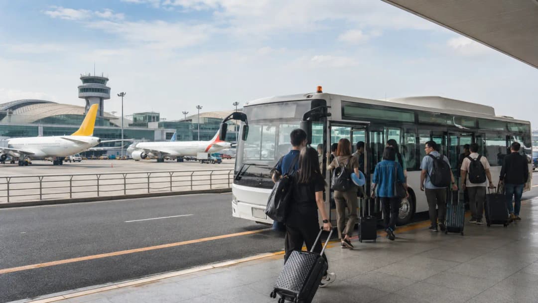 Passengers boarding an airport shuttle for a terminal transfer in Manila