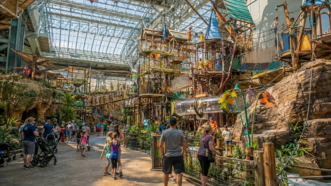 Parents and children exploring a colorful supervised indoor adventure play attraction