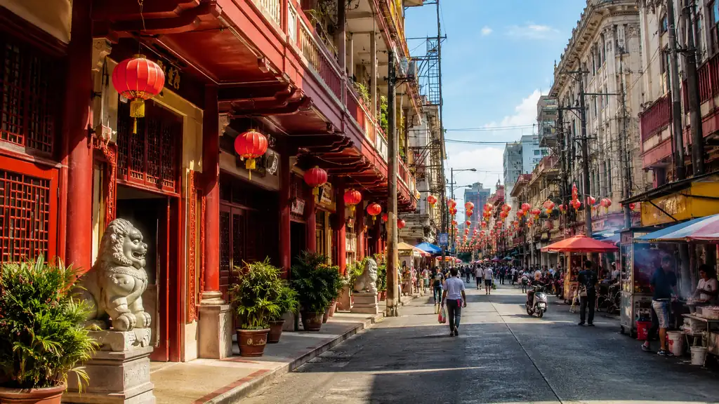Binondo Manila food street with red lanterns and historic shophouses on a bright morning