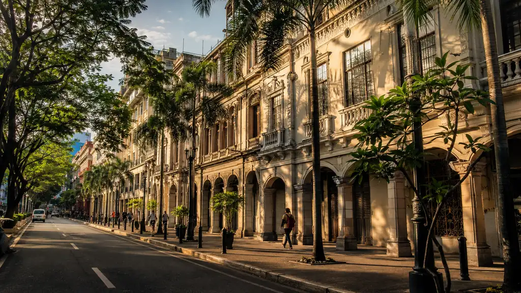 Historic Escolta street in Manila with tropical trees and early twentieth-century commercial architecture