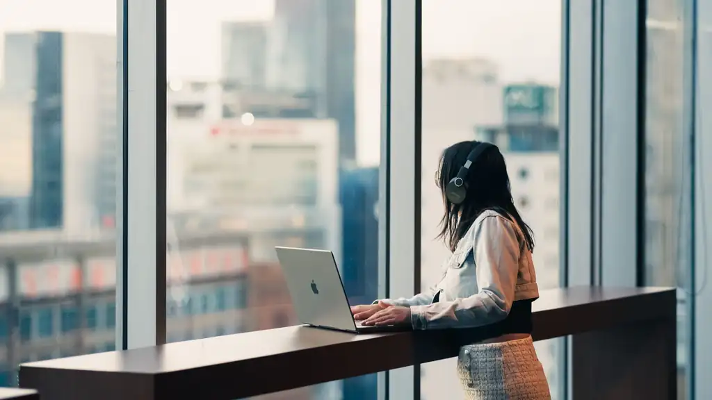 Remote worker with laptop at a shaded public terrace overlooking the Pasay and Manila Bay skyline